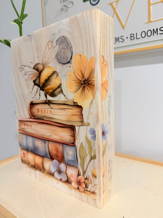 Bee, flowers and books